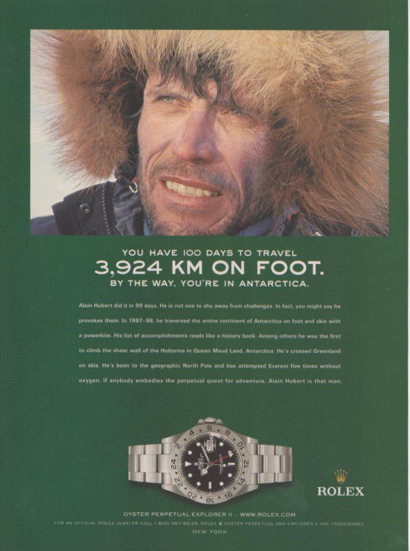 Vintage c.2000 Rolex Explorer II original print advertisement, polar explorer Alain Hubert in fur-trimmed parka with Antarctica headline and Oyster Perpetual Explorer II watch on green background
