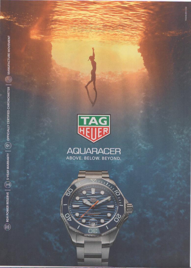 Vintage 2022 TAG Heuer Aquaracer original print advertisement, freediver silhouetted against golden water surface above deep blue ocean with blue dial dive watch