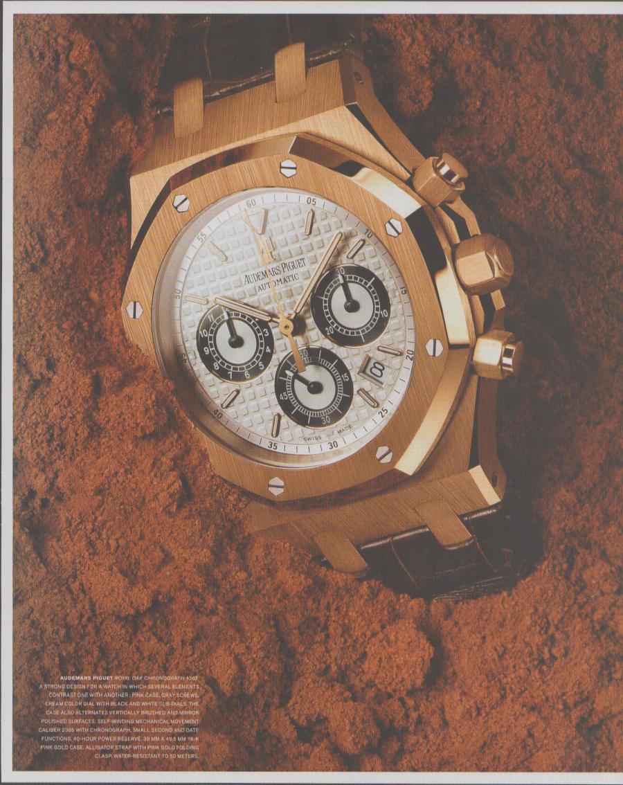Vintage 2000s Audemars Piguet Royal Oak Chronograph original print advertisement, pink gold case with cream panda dial and three black sub-registers resting on terra-cotta stone surface