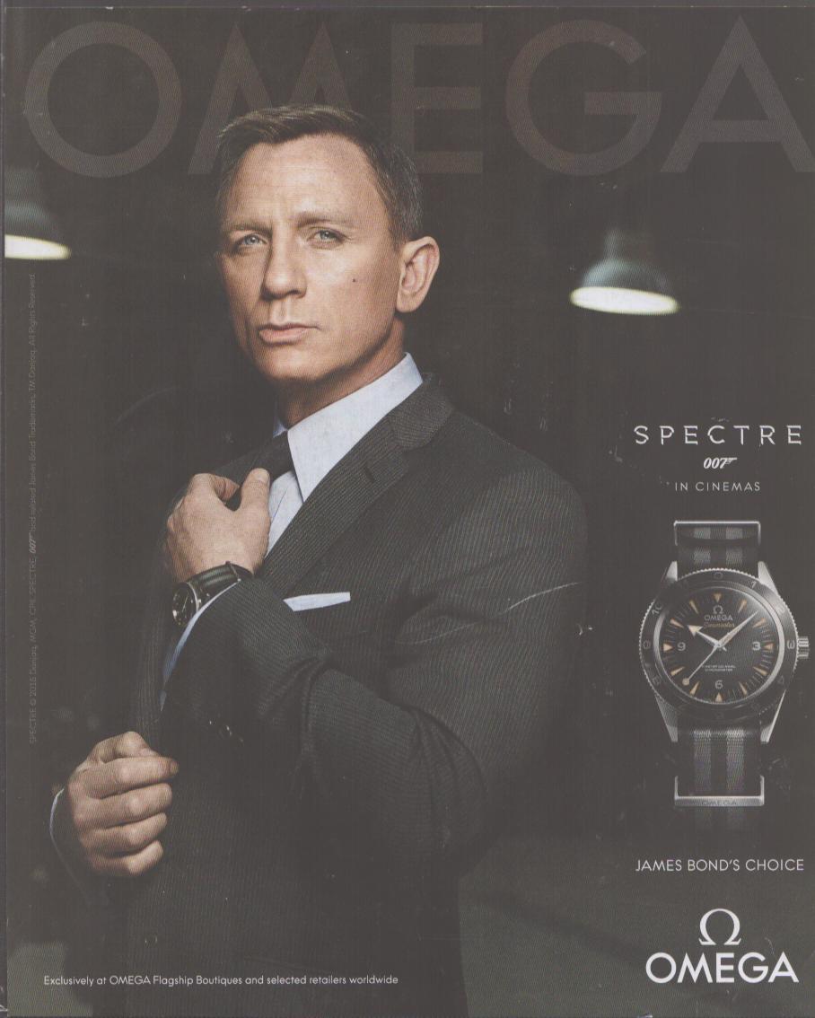 Vintage 2015 Omega Seamaster 300 Spectre original print advertisement, Daniel Craig as James Bond in dark suit adjusting tie with watch visible on wrist