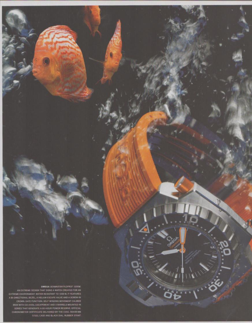 Vintage 2000s Omega Seamaster Ploprof 1200M original print advertisement, dramatic underwater scene with orange discus fish and the watch on an orange rubber strap against a dark blue background