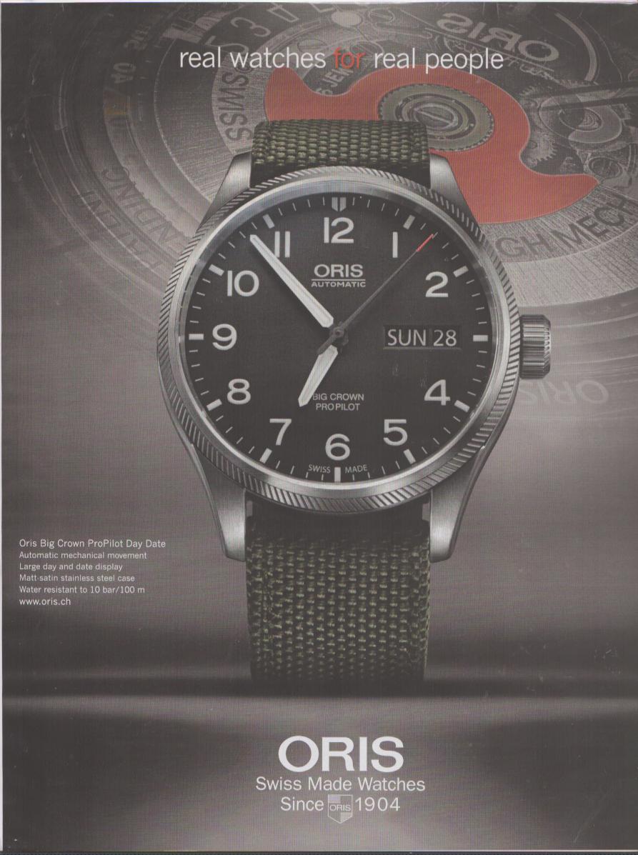Vintage 2000s Oris Big Crown ProPilot Day Date original print advertisement, black dial pilot watch on olive NATO strap with 'real watches for real people' tagline