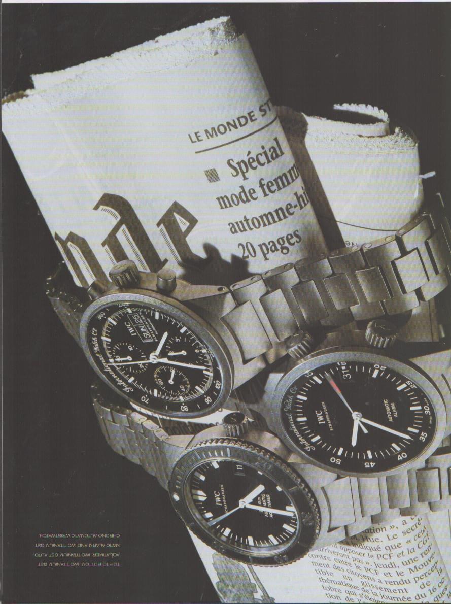 Vintage 1990s IWC GST Titanium original print advertisement, three IWC sport watches arranged on a rolled Le Monde newspaper against a dark background